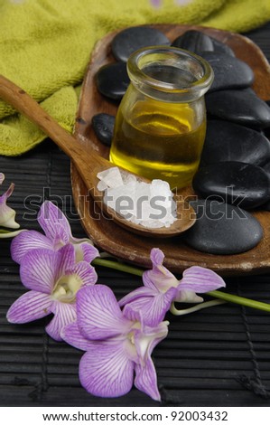 spa concept (zen stones, spa salt in bowl , Massage oil, orchid,)