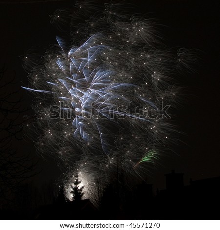 Fireworks display above the silhouette of a city street.