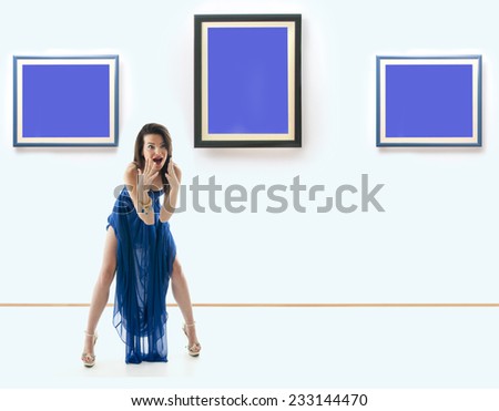 Woman standing inside a gallery in front of three picture frames and screaming. Images are fill with blue color useful for copy space.\
 NOTE:This image is composite of more photos.