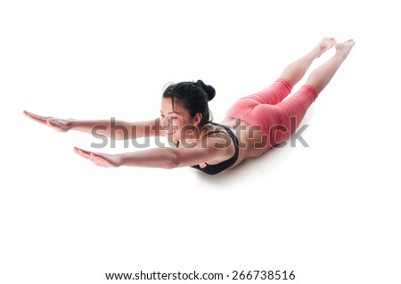 A woman moves into Upward Facing Dog pose, part of a stomach\'s exercises