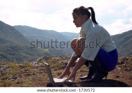 Girl with laptop at nature surroundings