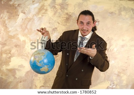 Businessman holding globe with money - Parody on earning money