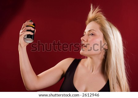 Woman\'s portrait with deodorant spray on her hair