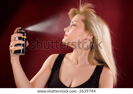 Woman's portrait with deodorant spray on her hair
