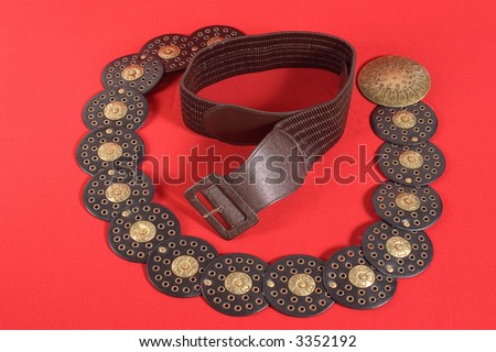 Females fashion belt on red backgrounds