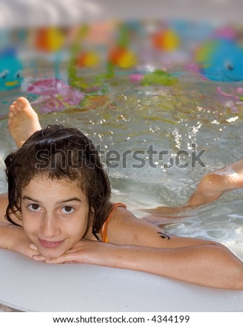 stock photo Young wet girl child swimming in swimmingpool