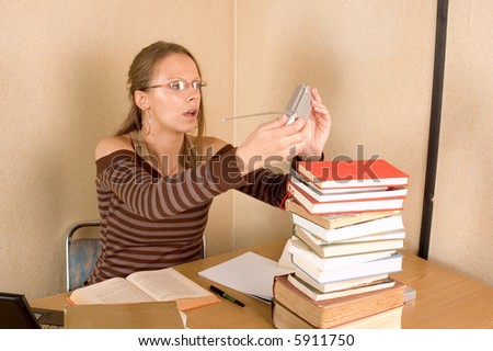 Student girl with books and laptop listening music