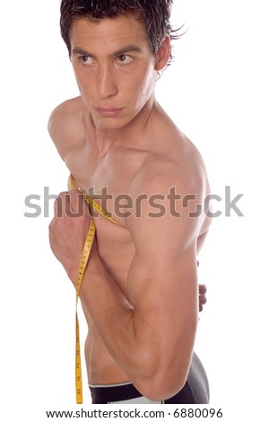 stock photo Young pretty man measuring his perfect body isolated on white