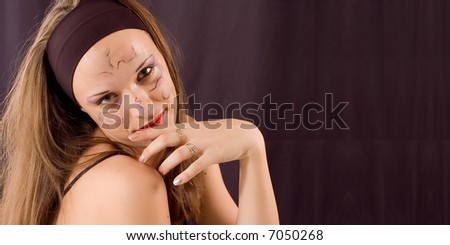 Young girl portrait with drawn ornament on face