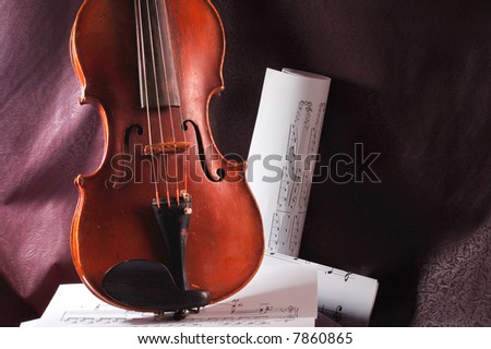 Violin and musical note on sheet of paper
