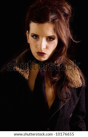 Portrait beautiful young woman dressed in leather coat