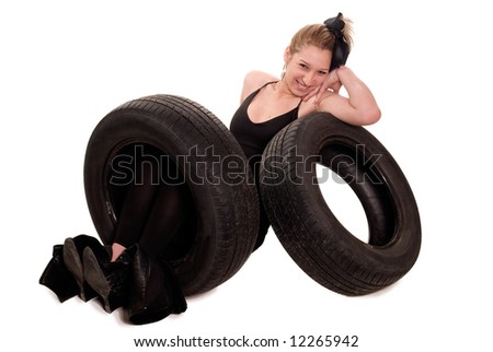 Young sexy girl with a car wheel