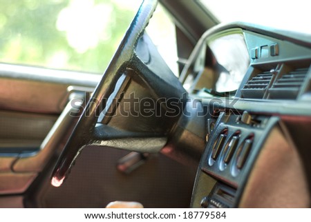 Interior of the car with steering wheel, key and speedmeter
