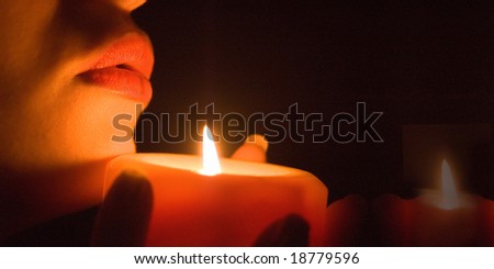Close up of woman\'s lips of candle light, DOF is shalow
