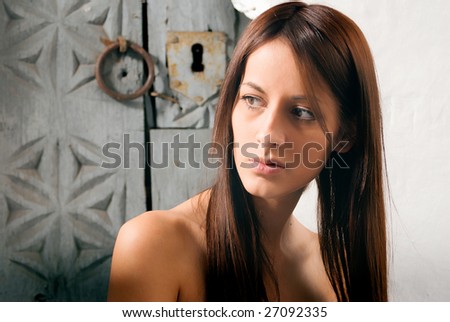 Portrait beautiful woman with lock of the door at backgrounds