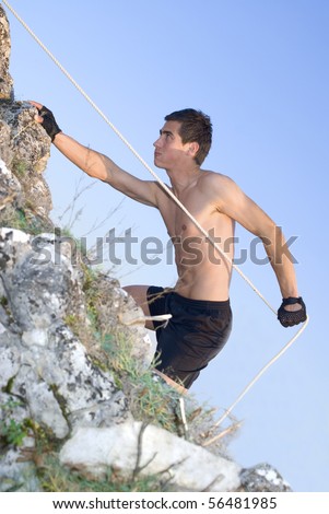 Rock climber man against blue sky