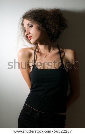 Young adult girl posing with strong contrast of light
