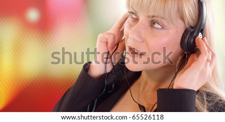 Young blondie woman listening music on headphone