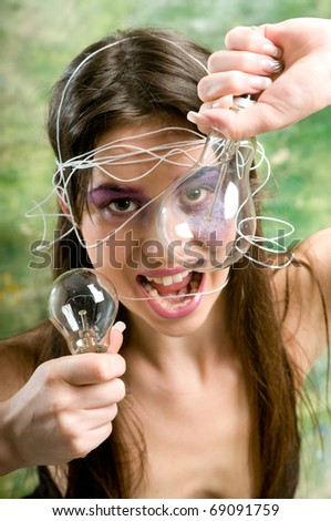 Woman with open mouth holding classical bulb and looking at camera
