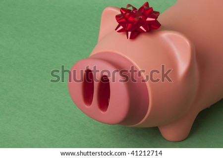 This pig with a bow encourages you to give the gift of savings this holiday season!