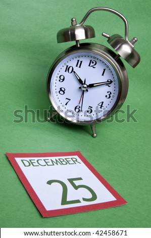 Running out of time before the holiday season.  Clock with santa hat in traditional red and green.