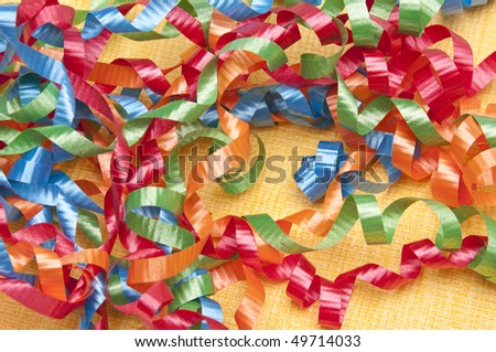 Party streamers on a yellow background.