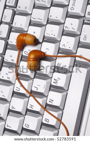 Laptop Keyboard Image with Headphones Audio Technology Concept.