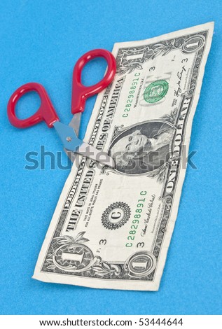 Quirky Red Scissors Cut Through a Dollar Bill for a Financial Concept.