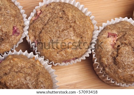 Healthy Whole Wheat Rhubarb Muffins on a Bamboo Wood Background.