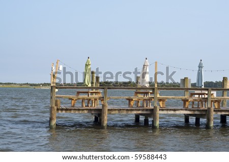 Outdoor Restaurant with Tables on a Ocean Dock.