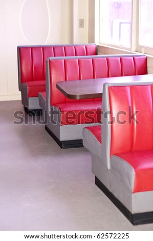 Image of a Retro Diner with Empty Red Booths and Tables