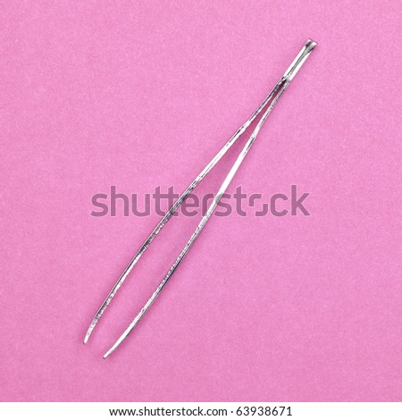 Small Tweezers on Pink Background.  Everyday Object.