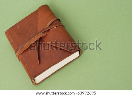 Old Leather Journal on a Green Background.