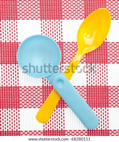Meal Time Concept with Vibrant Colored Spoons on a Red and White Background.