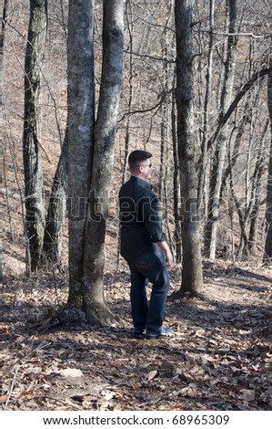 Man Walking in the Woods Seen from Behind.