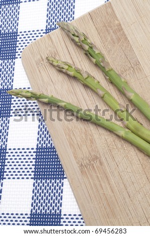 Fresh Asparagus Food Background on Blue with Kitchen Block.