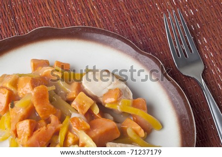 Chicken Sweet Potato and Pearl Onion Dinner with Sauce and Yellow Pepper Slivers.