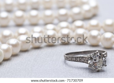 stock photo Antique Wedding Ring and Pearls with Focus on Ring