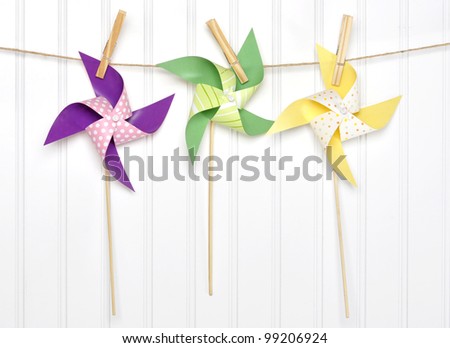 Vibrant Summer Party Pinwheels on a Clothesline with White Background.
