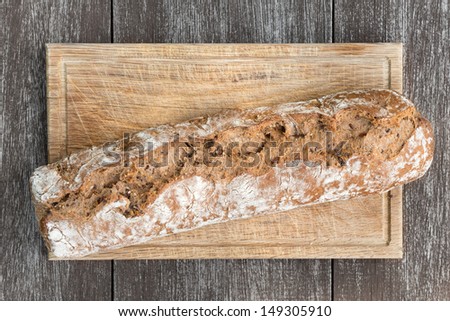 Bread on wooden board and table