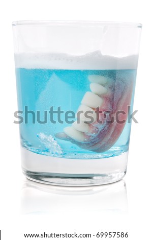 stock photo : Cleaning dentures in glass