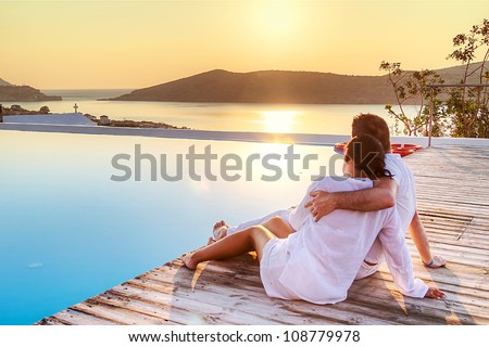 Couple In Hug Watching Sunrise Together