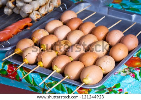 Barbecued eggs on the stick on the local market in Thailand