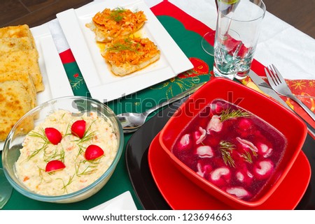 Christmas eve table with glass of wine and traditional polish food