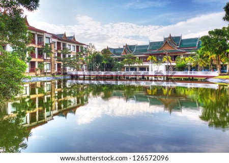 Oriental architecture reflected in the pond at sunrise, Thailand
