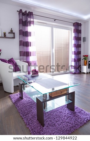 Modern white living room interior with purple decorations