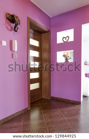 Purple hall interior with brown tiles