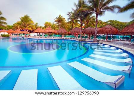 PLAYA DEL CARMEN, MEXICO - JULY 12, 2011: Scenery of luxury swimming pool at RIU Yucatan Hotel on July 12, 2011 in Playa del Carmen. RIU Hotels & Resorts has more than 100 hotels in 19 countries.