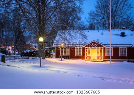 Winter scenery with red wooden house  in Sweden at night