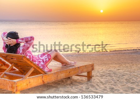 Beautiful woman relaxing at sunrise over Red Sea in Egypt